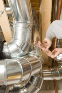 Ducts being sealed by a technician.