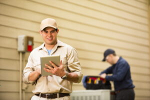 Two technicians servicing a damaged boiler.