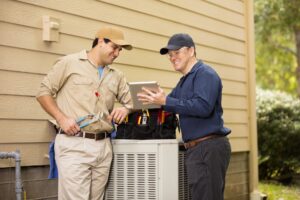 air-conditioning-technicians-installing-new-AC-cabinet